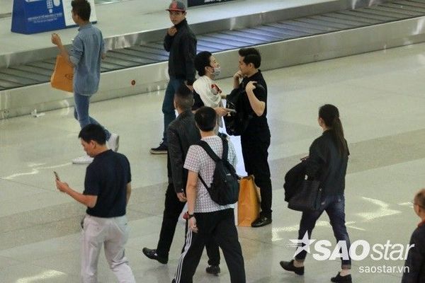 Cặp đôi vô tư đùa giỡn với nhau trong lúc đợi lấy hành lý.